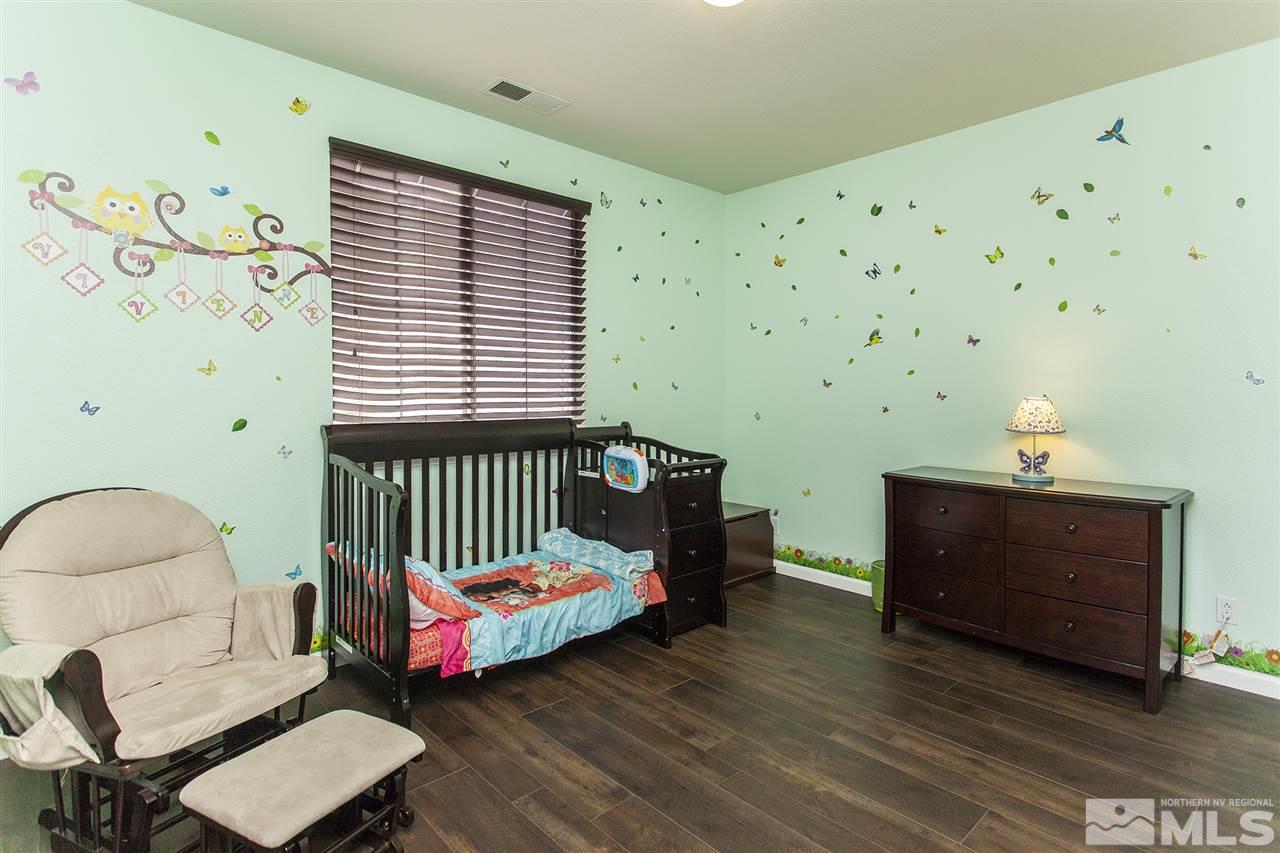 570 Needles Court Reno, NV 89521 - Photo 12 of 18 a bedroom with a bed and a window