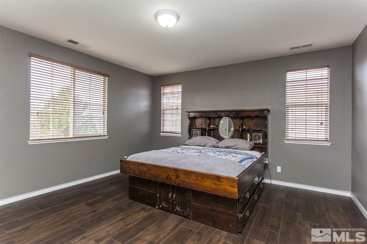 570 Needles Court Reno, NV 89521 - Photo 17 of 18 a bedroom with a bed and windows
