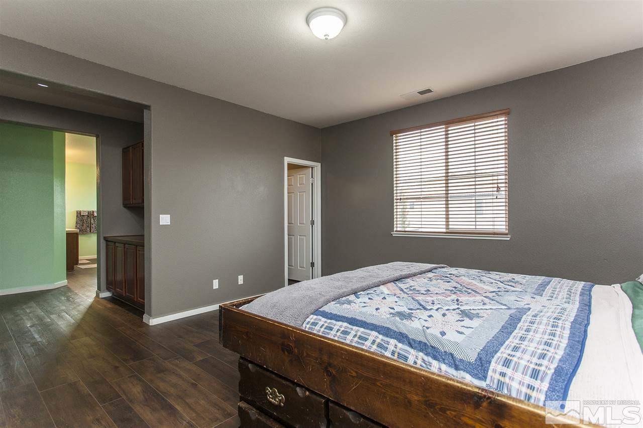 570 Needles Court Reno, NV 89521 - Photo 18 of 18 a bedroom with a bed and wooden floor