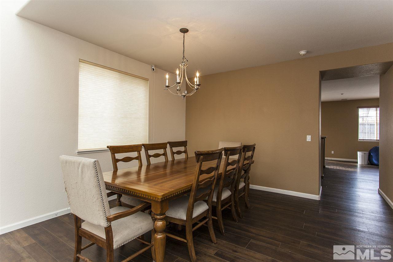 570 Needles Court Reno, NV 89521 - Photo 7 of 18 a view of a dining room with furniture and wooden floor