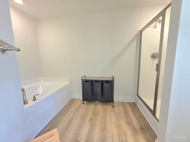 a bathroom with a bathtub and a shower