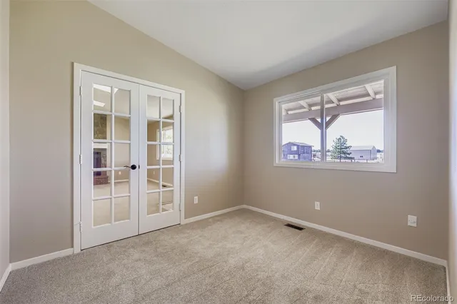 an empty room with windows and closet