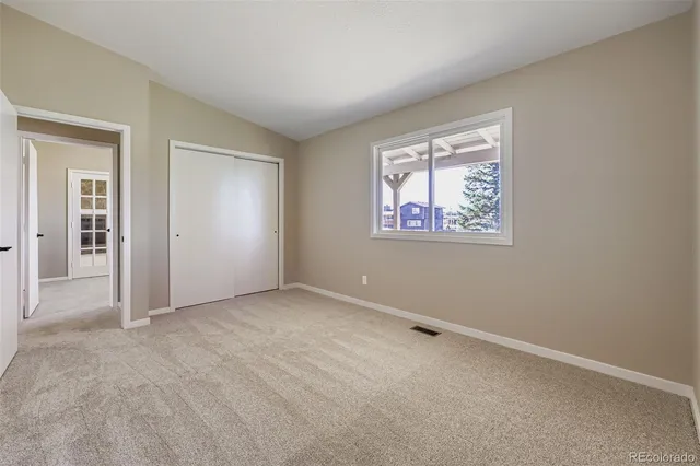 an empty room with a empty space and windows