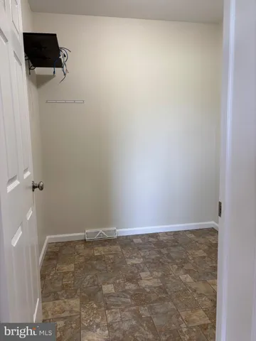 a spacious bedroom with a bed and a chandelier