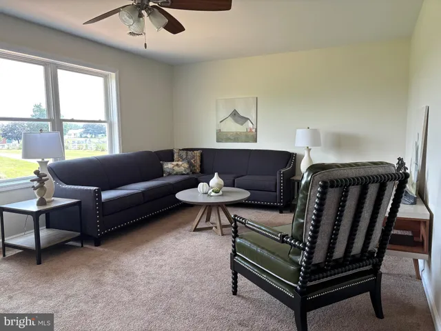 a bathroom with a granite countertop sink a large mirror and a window