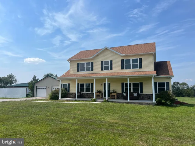 a front view of a house with a garden and porch