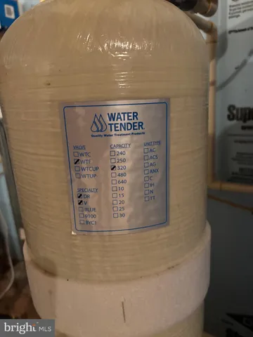 a view of a backyard with barn and wooden fence