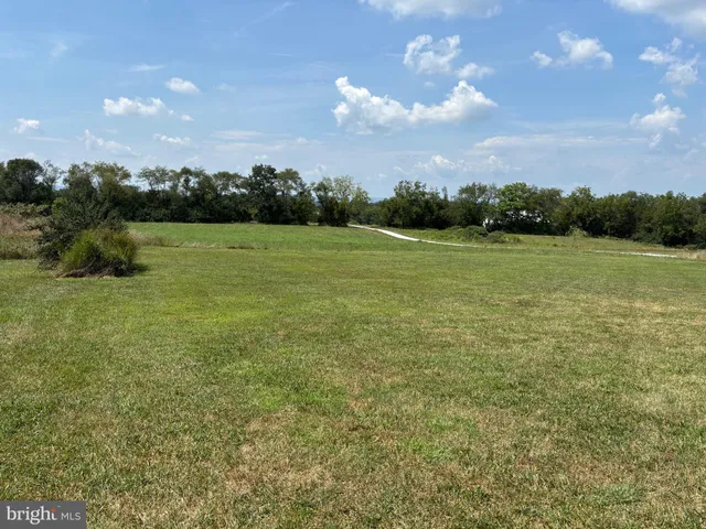 a room with lots of wooden furniture and stainless steel appliances