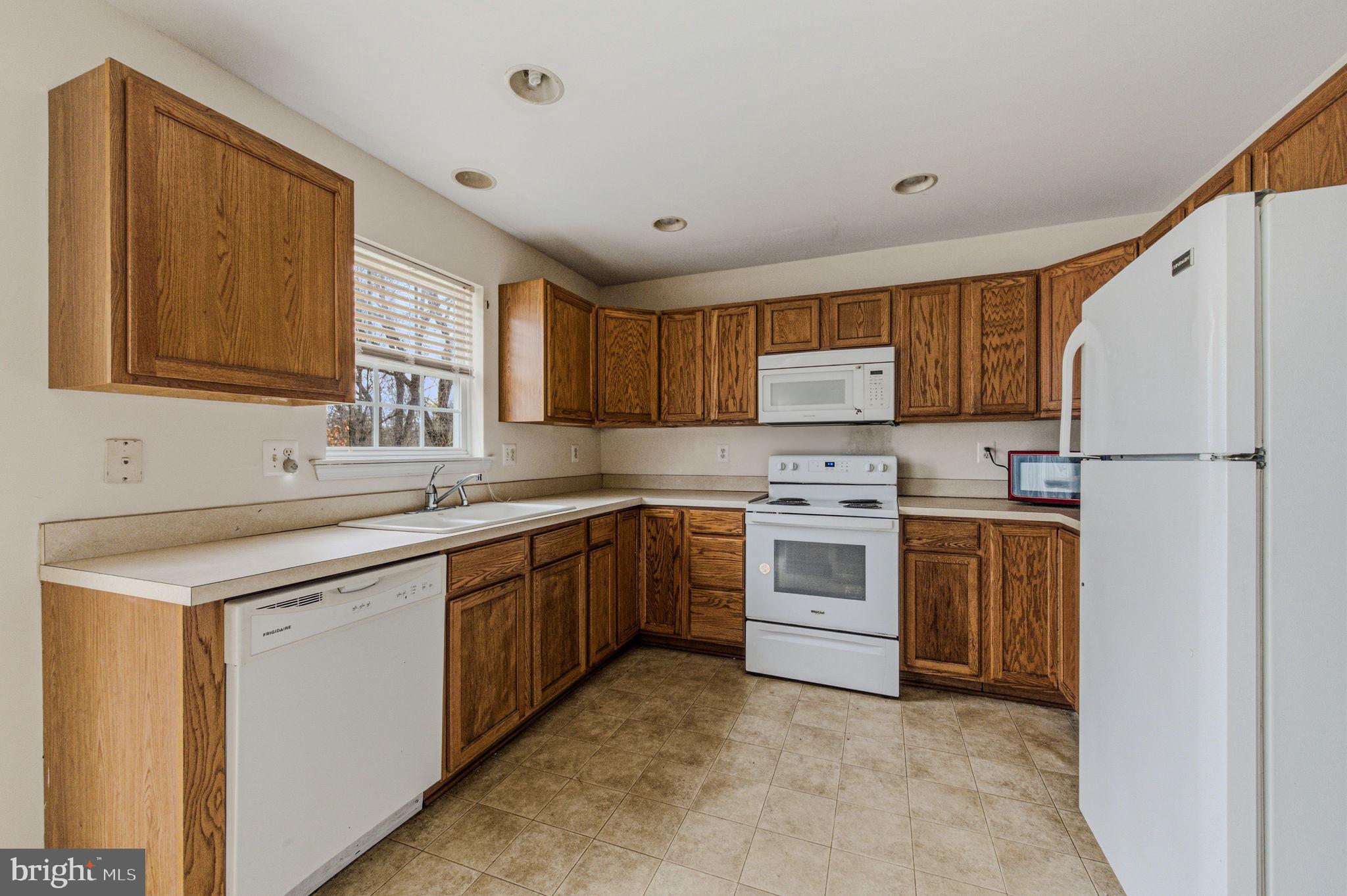 99 Jack's Way Camden, DE 19934 - Photo 13 of 30 a kitchen with stainless steel appliances granite countertop a sink stove and refrigerator