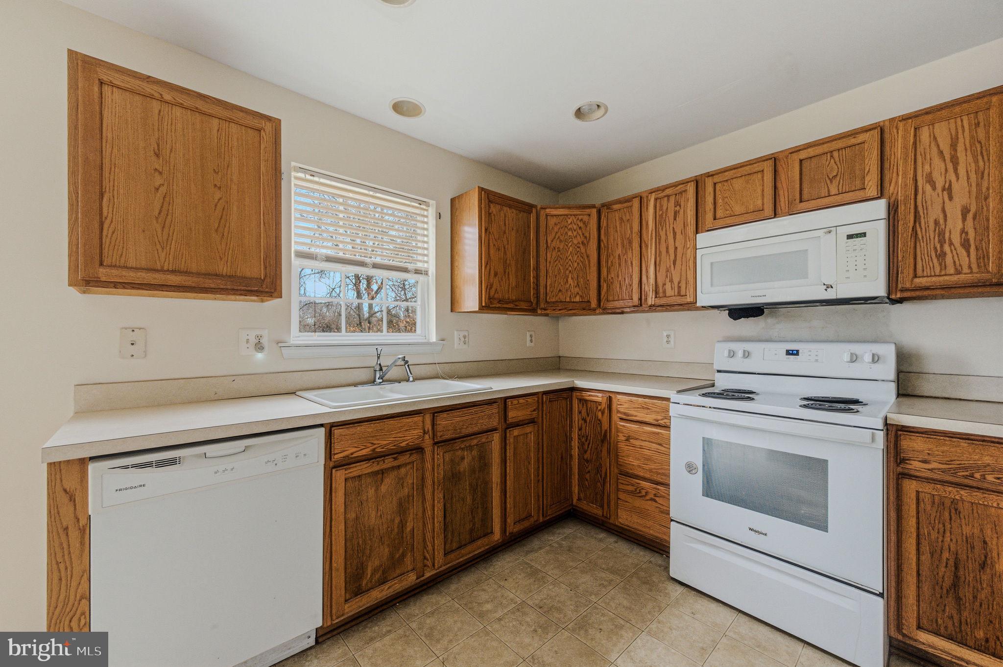 99 Jack's Way Camden, DE 19934 - Photo 15 of 30 a kitchen with sink cabinets and window