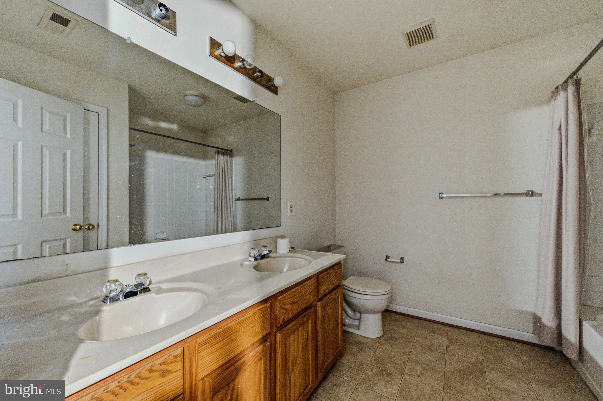 99 Jack's Way Camden, DE 19934 - Photo 20 of 30 a bathroom with a double vanity sink toilet and a mirror