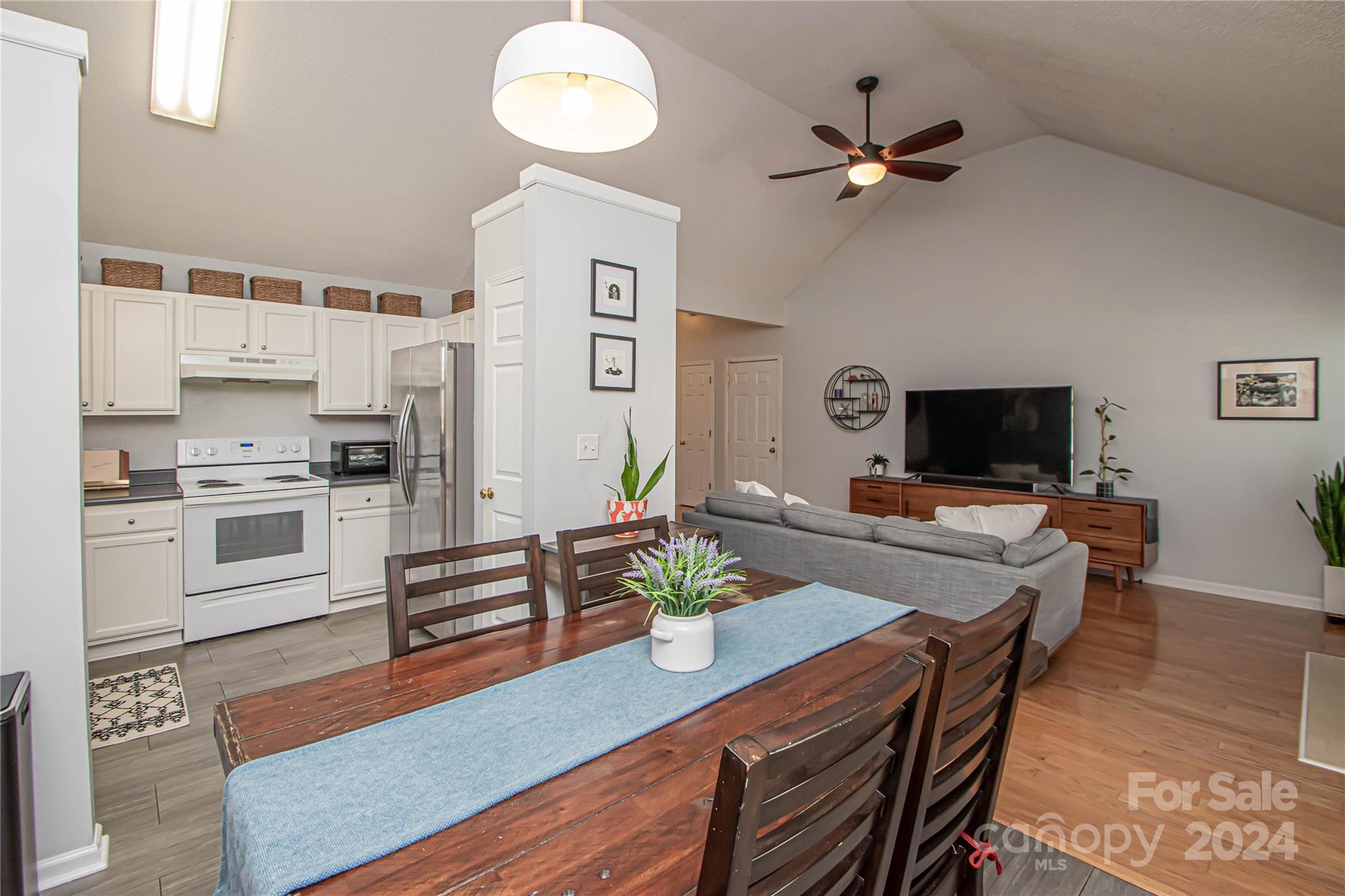 10135 Faires Farm Road Charlotte, NC 28213 - Photo 6 of 31 a living room with furniture kitchen area and a flat screen tv