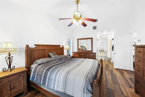 a bedroom with a bed and wooden floors
