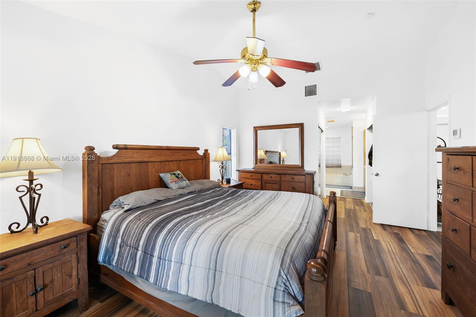 4201 Southwest 78th Drive Davie, FL 33328 - Photo 11 of 28 a bedroom with a bed and wooden floors