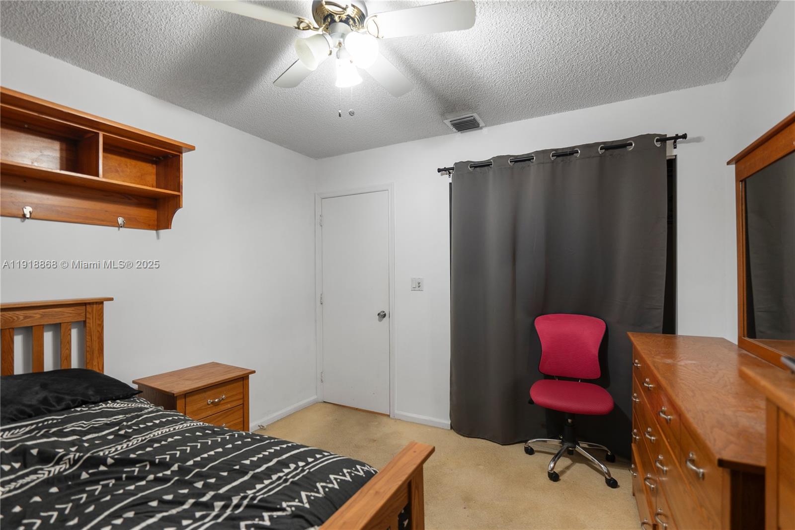 4201 Southwest 78th Drive Davie, FL 33328 - Photo 17 of 28 a bedroom with a bed dresser and a window