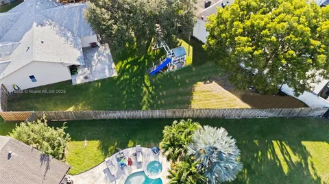 an aerial view of a house with a lake view
