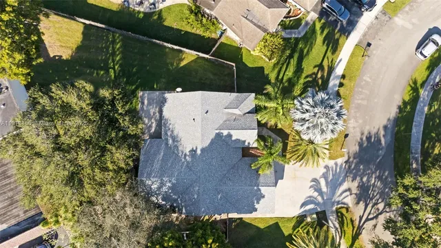 an aerial view of a house with a yard