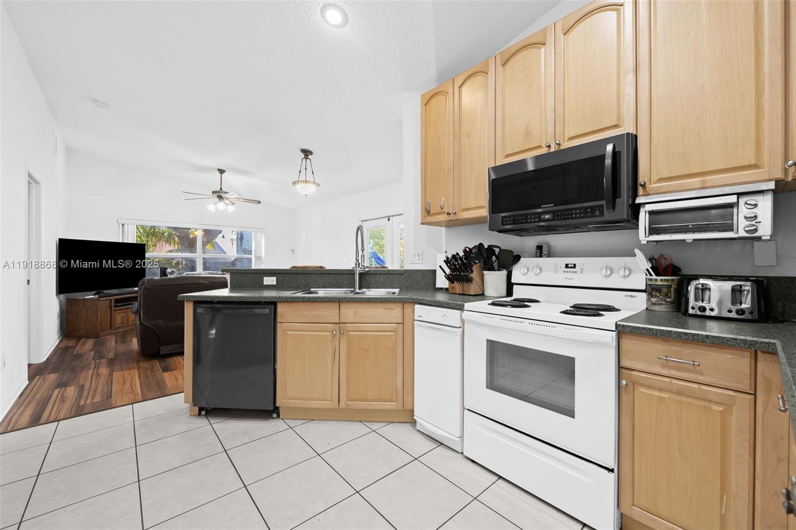 4201 Southwest 78th Drive Davie, FL 33328 - Photo 8 of 28 a kitchen with stainless steel appliances granite countertop a stove top oven a sink a counter space and cabinets