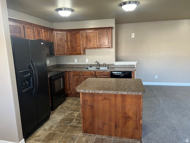 917 South Main Street, Unit H Layton, UT 84041 - Photo 5 of 19 Kitchen featuring black appliances, a center island, wood finish cabinets, dark countertops, and dark stone finish floors