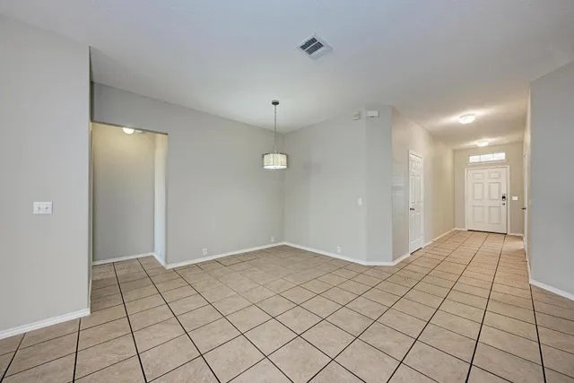 an empty room with fireplace and windows