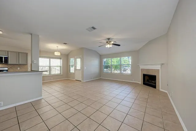 a kitchen with white cabinets a sink and appliances