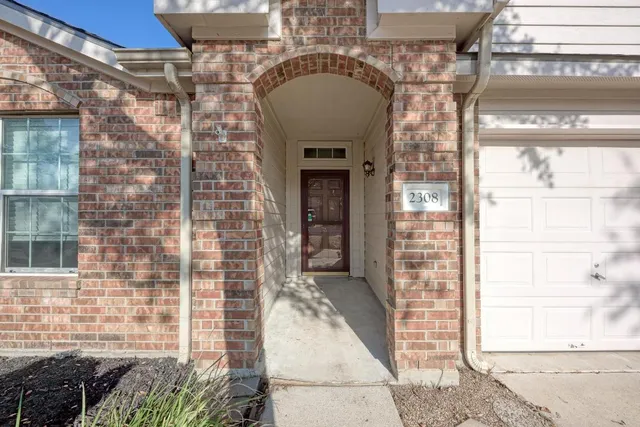 a view of a wooden door of the house