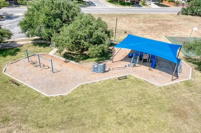 an aerial view of a house with a garden and swimming pool