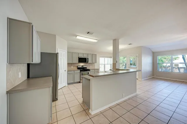 a kitchen with stainless steel appliances a sink and a refrigerator