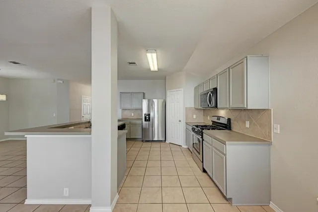 a kitchen with a stove a sink and a refrigerator