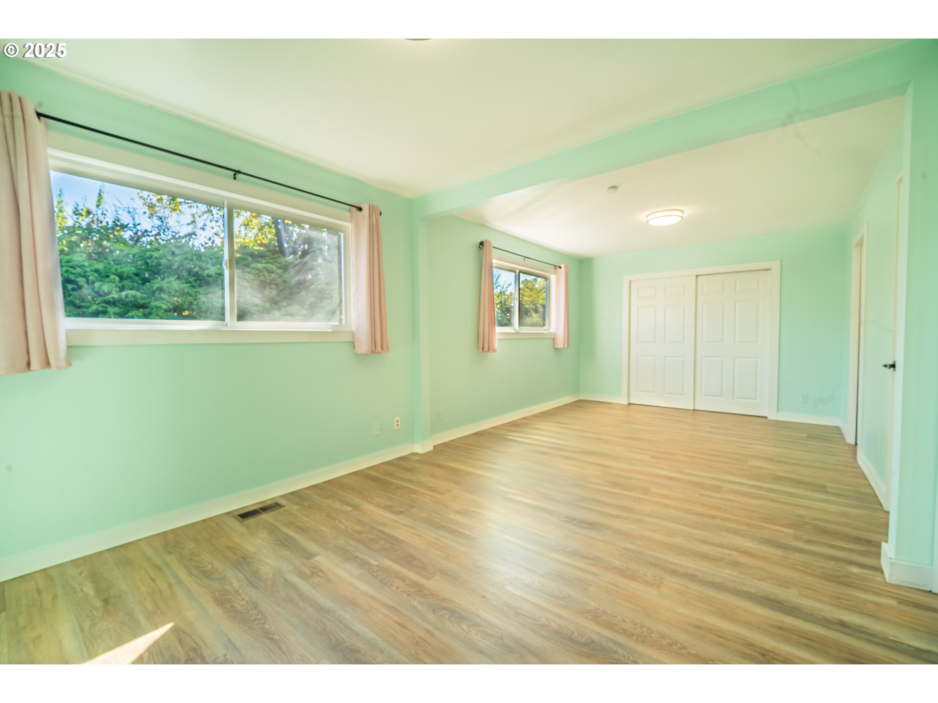 11910 Northeast Fremont Street Portland, OR 97220 - Photo 9 of 23 a view of empty room with wooden floor and fan