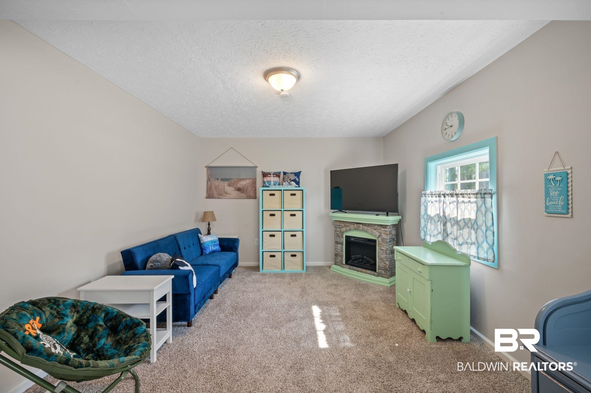 48513 Phillipsville Road Bay Minette, AL 36507 - Photo 35 of 50 Living room featuring a textured ceiling, light carpet, and a fireplace