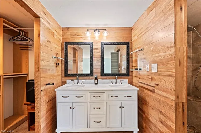 a bathroom with a double vanity sink mirror and