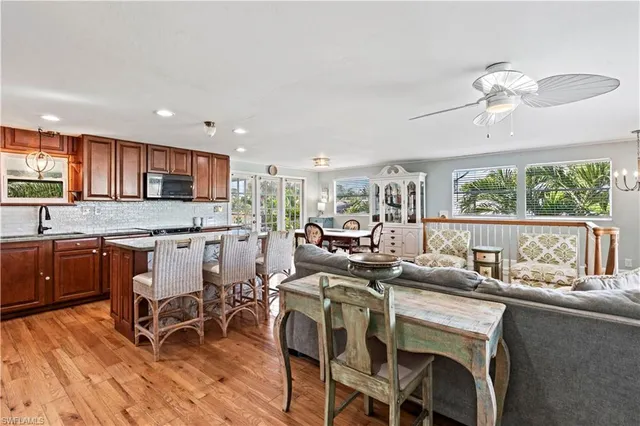 a kitchen with granite countertop a table chairs stove a sink and dishwasher