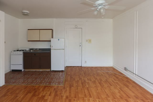 4735 North Beacon Street, Unit 411 Chicago, IL 60640 - Photo 10 of 11 a view of a kitchen with a sink cabinets and wooden floor