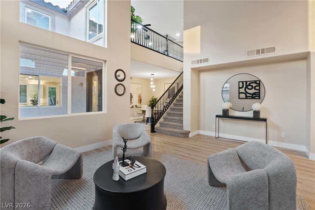 1662 Ravanusa Drive Henderson, NV 89052 - Photo 67 of 74 A dramatic two-story living area features a grand staircase and abundant natural light.