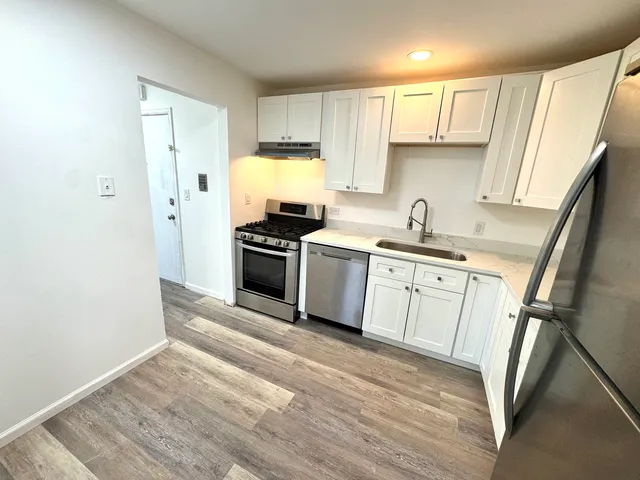 a kitchen with a sink stove and refrigerator