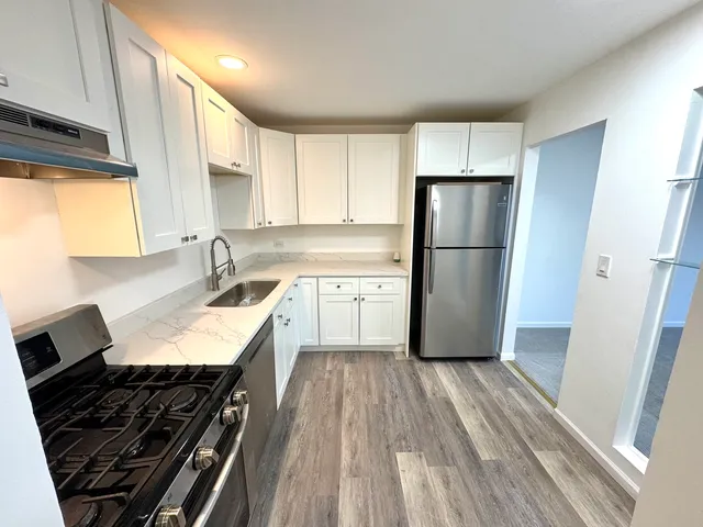 a kitchen with a sink stove and refrigerator