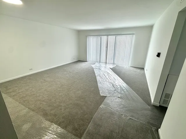 a bed sitting in a room next to a window