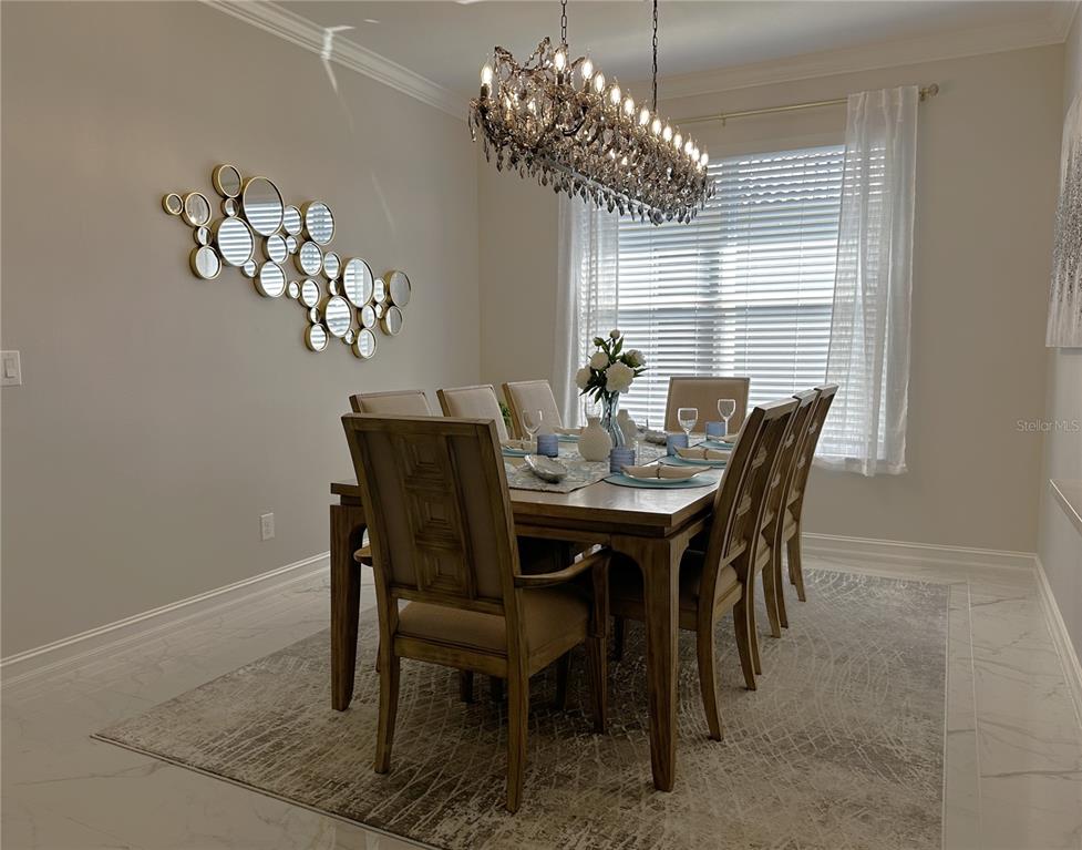 25191 Keygrass Court Punta Gorda, FL 33955 - Photo 13 of 66 a dining room with furniture and chandelier