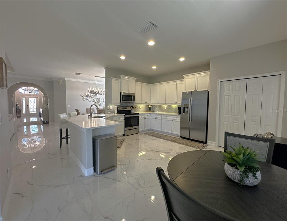 25191 Keygrass Court Punta Gorda, FL 33955 - Photo 14 of 66 a kitchen with refrigerator and microwave