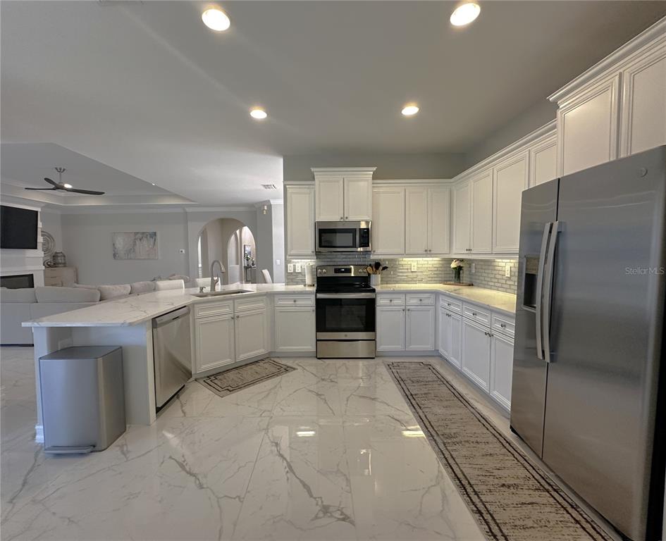 25191 Keygrass Court Punta Gorda, FL 33955 - Photo 17 of 66 a large kitchen with cabinets stainless steel appliances and a counter space