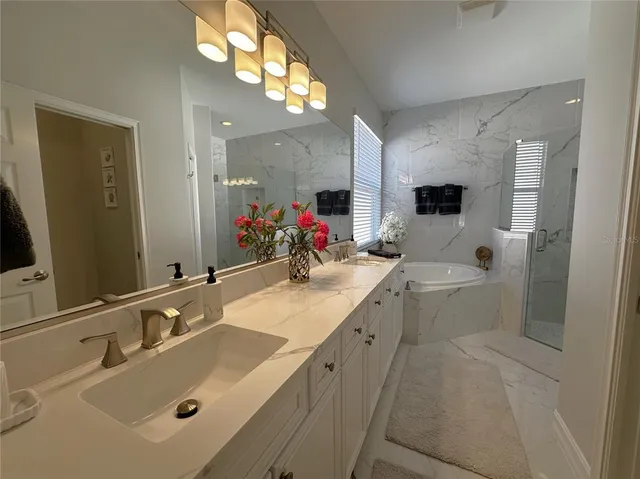 a bathroom with a double vanity sink and a mirror