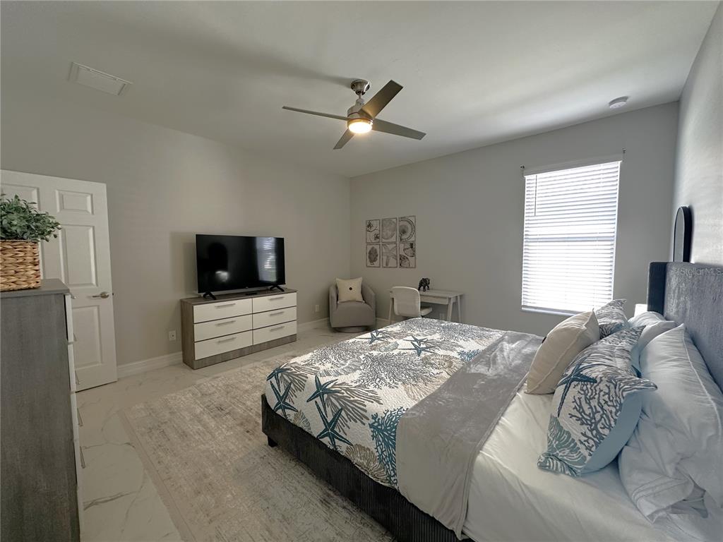 25191 Keygrass Court Punta Gorda, FL 33955 - Photo 24 of 66 a bedroom with a bed and a tv
