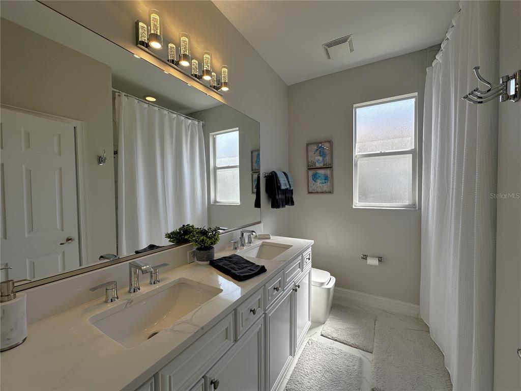 25191 Keygrass Court Punta Gorda, FL 33955 - Photo 29 of 66 a bathroom with a double vanity sink and a mirror