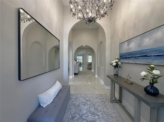 a living room with furniture and a chandelier