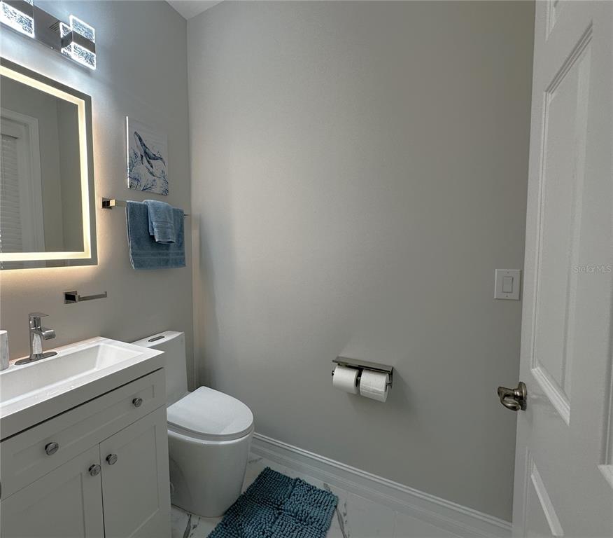 25191 Keygrass Court Punta Gorda, FL 33955 - Photo 35 of 66 a bathroom with a toilet a sink and mirror