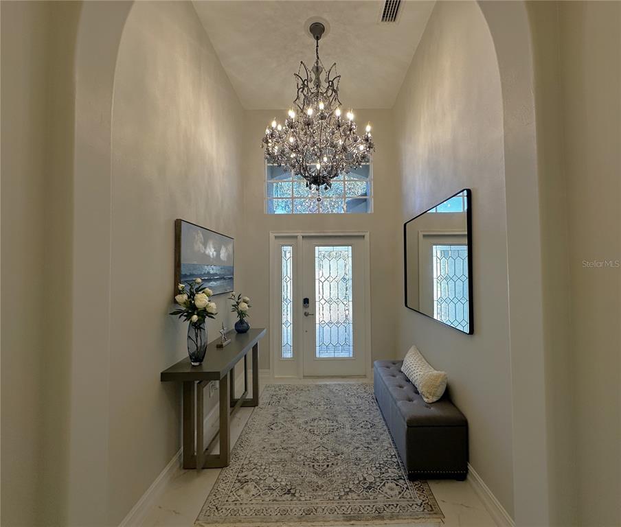 25191 Keygrass Court Punta Gorda, FL 33955 - Photo 4 of 66 a living room with furniture and a chandelier