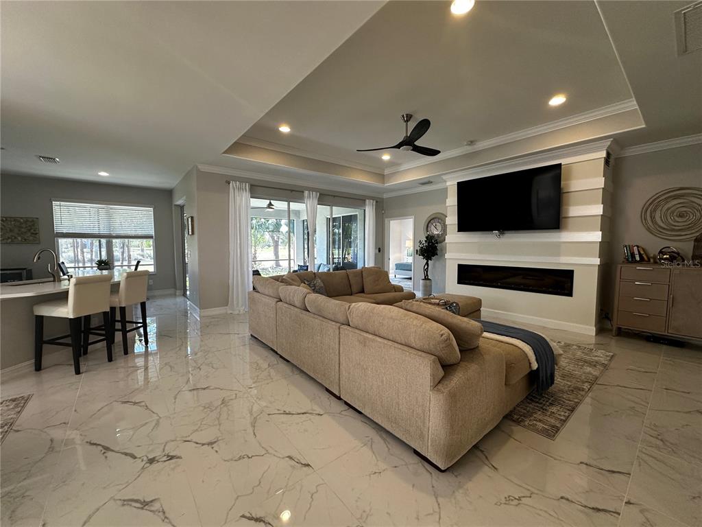 25191 Keygrass Court Punta Gorda, FL 33955 - Photo 8 of 66 a living room with furniture and a flat screen tv