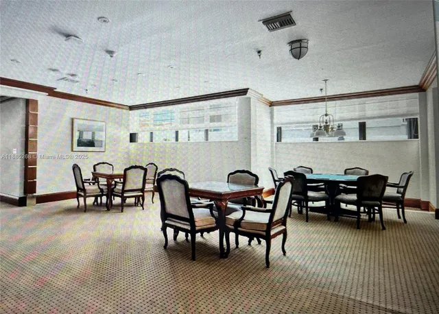 a room with pool table and windows