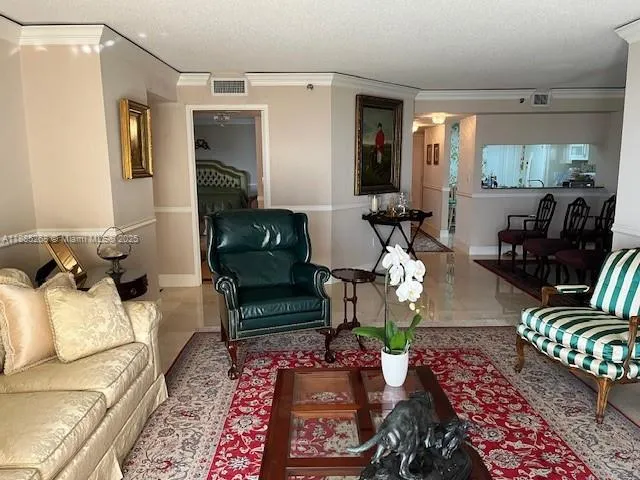 a living room with furniture rug and a window